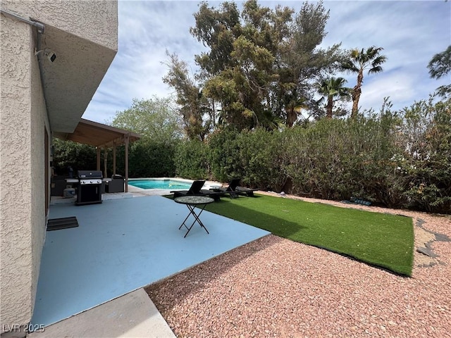 view of yard with an outdoor pool and a patio area