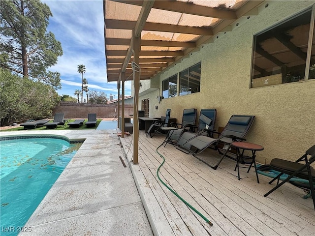 view of swimming pool with fence, a wooden deck, and a fenced in pool
