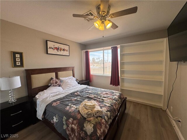 bedroom with dark wood finished floors and a ceiling fan