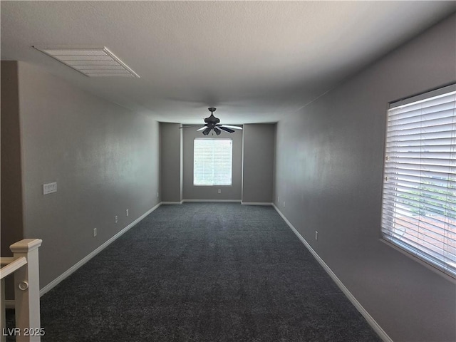 carpeted spare room with ceiling fan