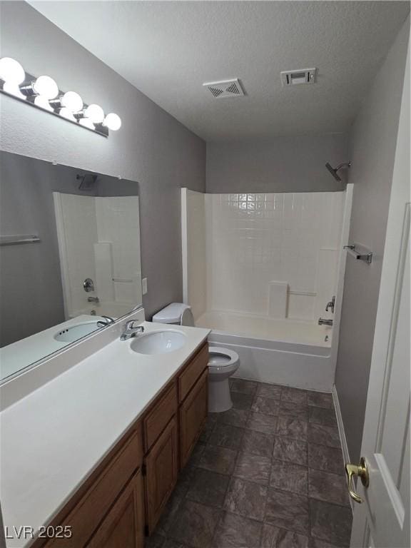 full bathroom with vanity, tub / shower combination, toilet, and a textured ceiling