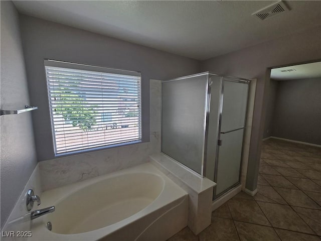 bathroom featuring tile patterned flooring and separate shower and tub