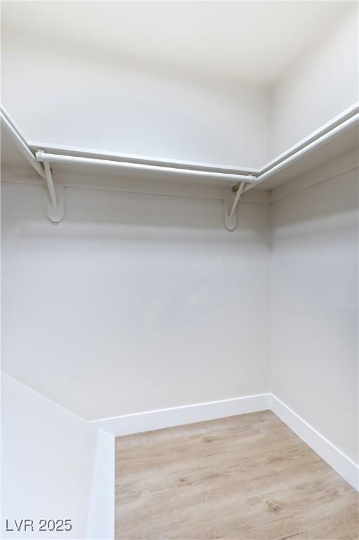 walk in closet featuring light hardwood / wood-style floors