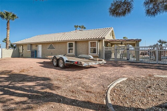 rear view of property with ceiling fan