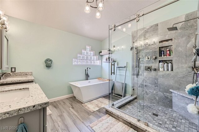 bathroom with vanity, wood-type flooring, and plus walk in shower