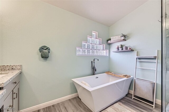 clothes washing area with light hardwood / wood-style flooring