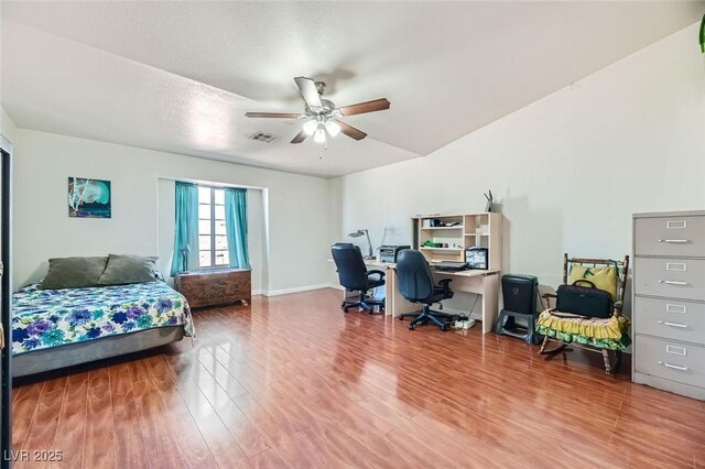 bedroom featuring hardwood / wood-style flooring, a textured ceiling, and ceiling fan