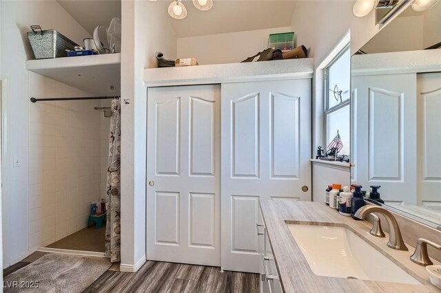 bathroom featuring vanity, curtained shower, and hardwood / wood-style floors