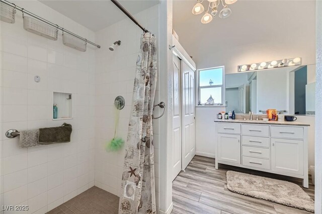 bathroom featuring vanity, wood-type flooring, and walk in shower