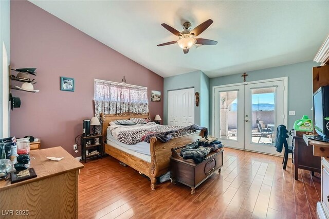 bedroom featuring lofted ceiling, hardwood / wood-style flooring, ceiling fan, access to outside, and french doors