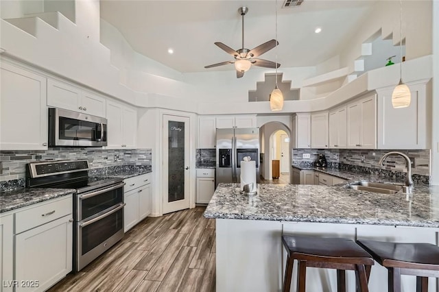 kitchen featuring stainless steel appliances, sink, and white cabinets