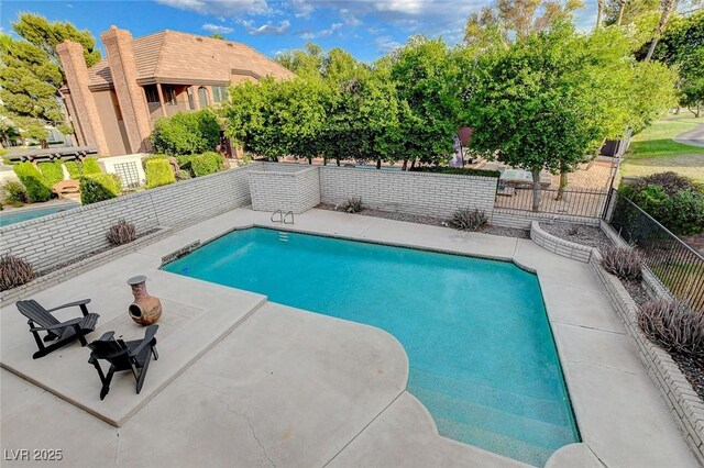 view of swimming pool with a patio area