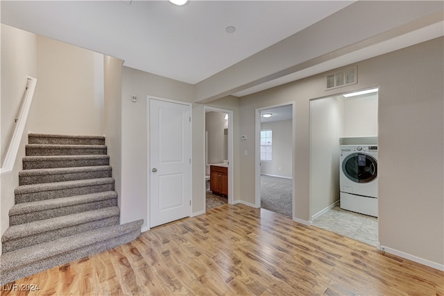 washroom featuring washer / dryer and light hardwood / wood-style floors