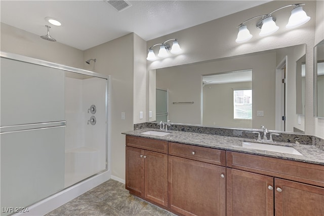 bathroom with vanity, ceiling fan, and an enclosed shower