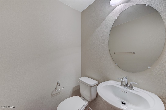 bathroom with toilet and sink