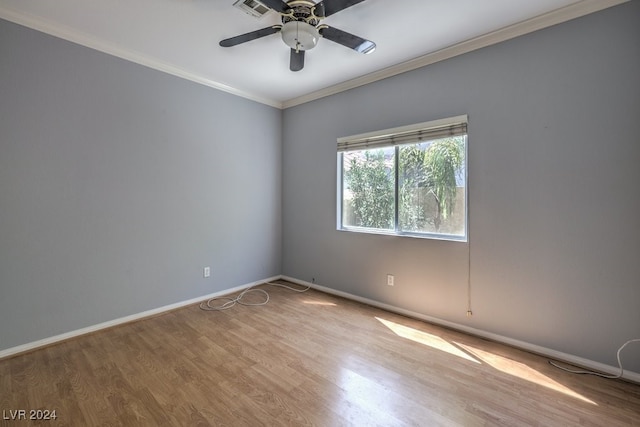 spare room featuring ceiling fan, ornamental molding, and light wood-type flooring