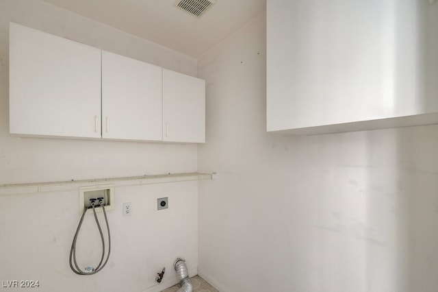 laundry area with electric dryer hookup, gas dryer hookup, cabinets, and washer hookup