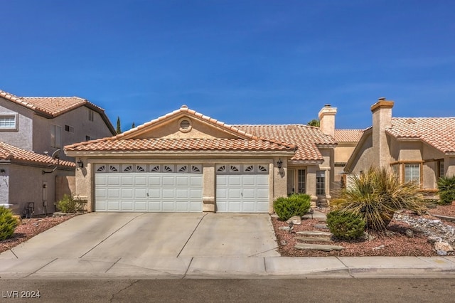 mediterranean / spanish house featuring a garage