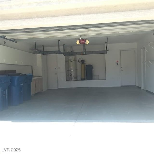 garage with secured water heater and a garage door opener