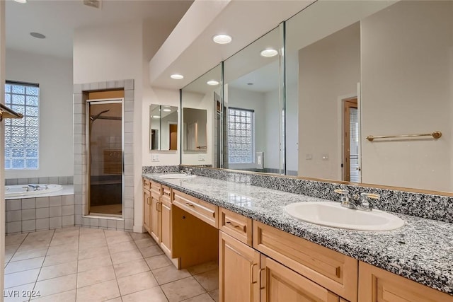 bathroom with tile patterned floors, vanity, and plus walk in shower