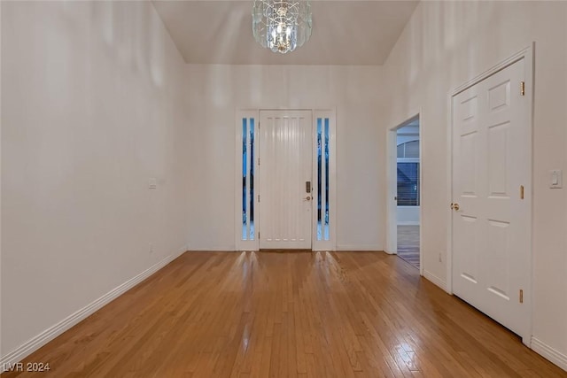 interior space with a chandelier and light hardwood / wood-style flooring