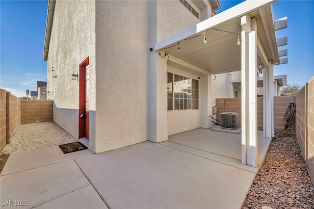 view of property exterior featuring central AC unit and a patio