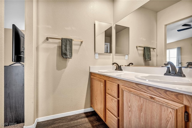 bathroom featuring vanity, hardwood / wood-style floors, and ceiling fan