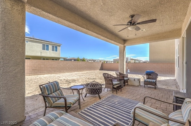 view of patio featuring a fire pit and ceiling fan