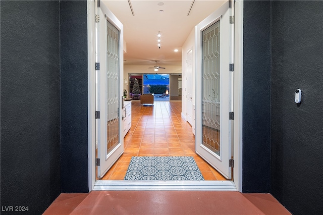 hall with light tile patterned floors