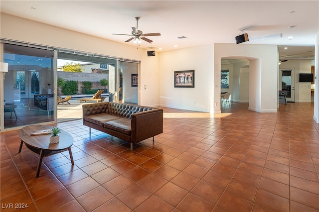 living room featuring tile patterned floors and ceiling fan