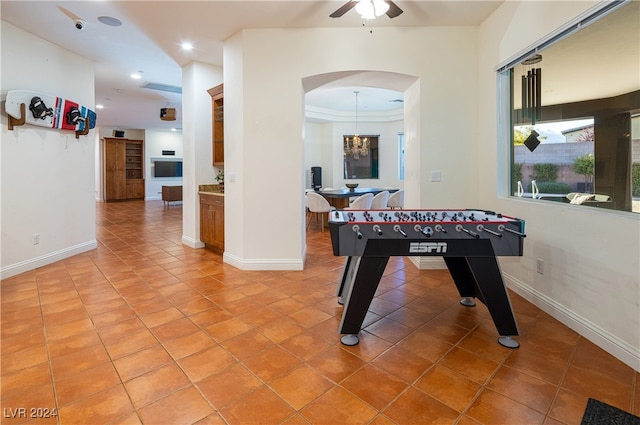 rec room featuring tile patterned floors and ceiling fan