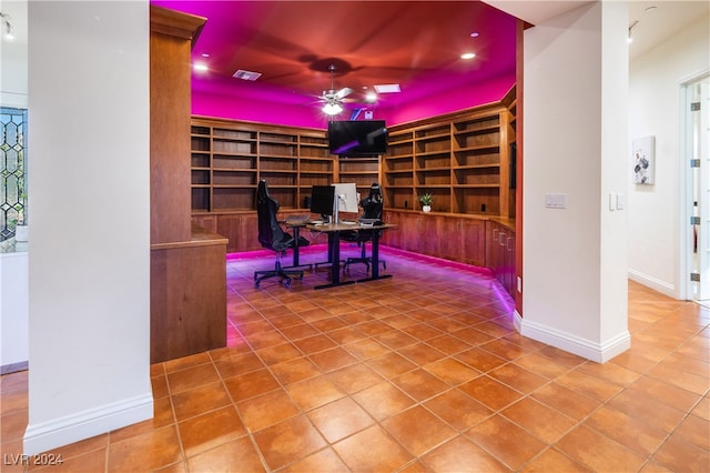 tiled home office with ceiling fan, built in features, and built in desk