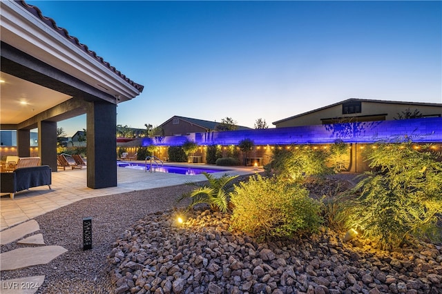 exterior space featuring a fenced in pool and a patio