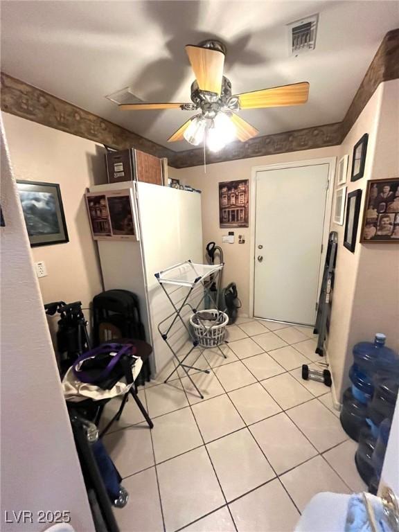 interior space featuring ceiling fan and light tile patterned floors