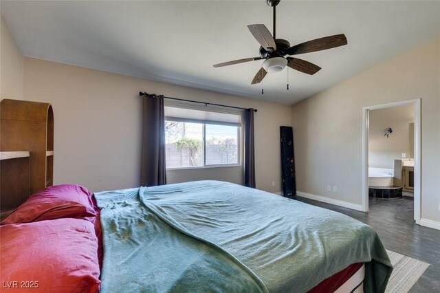 bedroom featuring ceiling fan, dark hardwood / wood-style floors, lofted ceiling, and ensuite bathroom