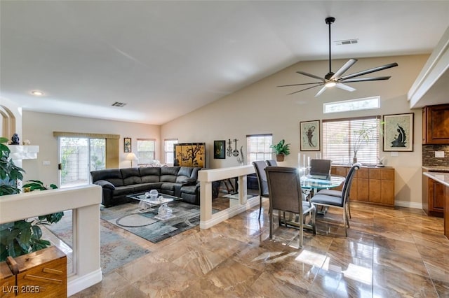 dining room featuring ceiling fan and lofted ceiling