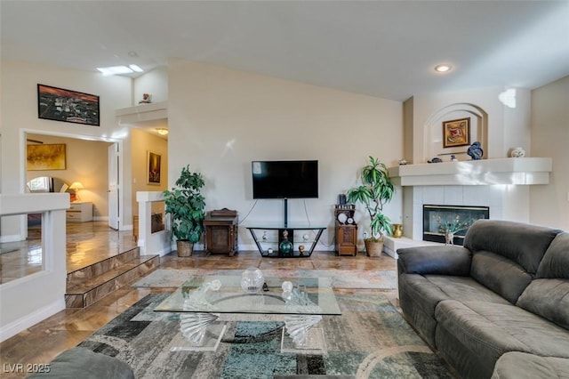 living room with a tile fireplace