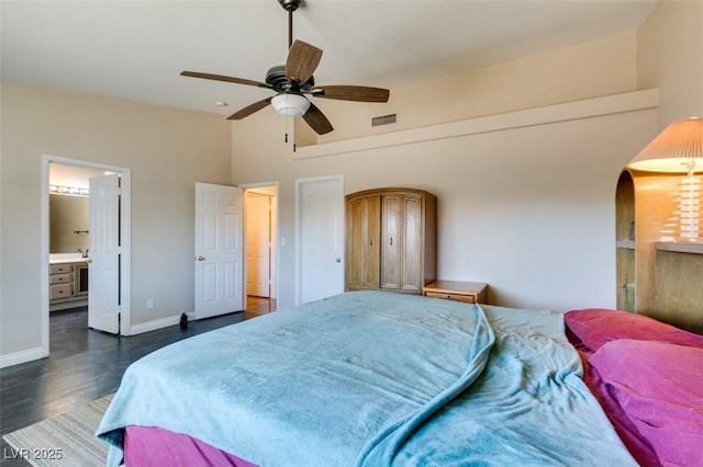 bedroom featuring ceiling fan, dark hardwood / wood-style flooring, and ensuite bath