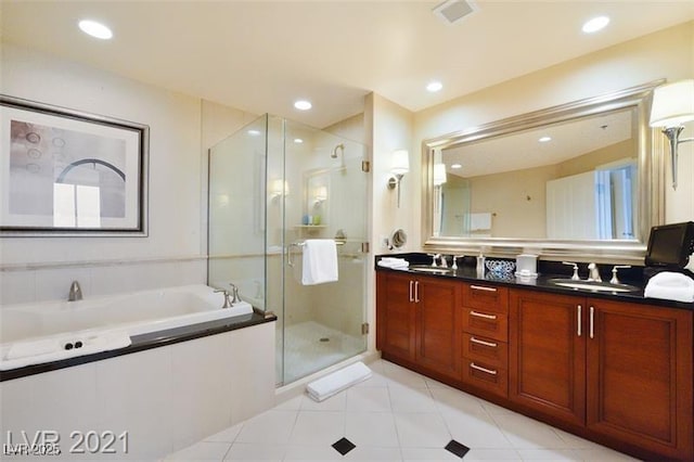 bathroom with plus walk in shower, vanity, and tile patterned flooring