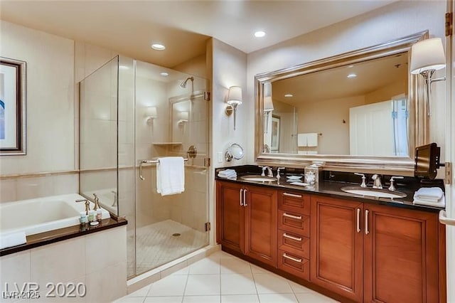 bathroom featuring shower with separate bathtub, vanity, and tile patterned floors