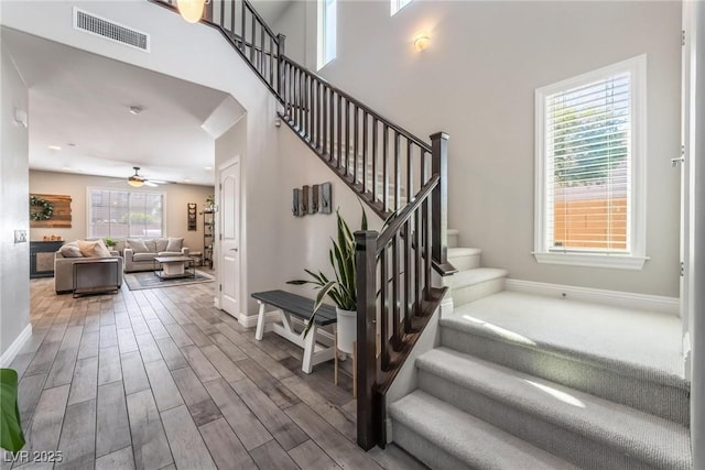 stairway featuring hardwood / wood-style flooring and ceiling fan