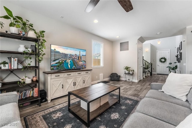 living room featuring dark hardwood / wood-style floors and ceiling fan