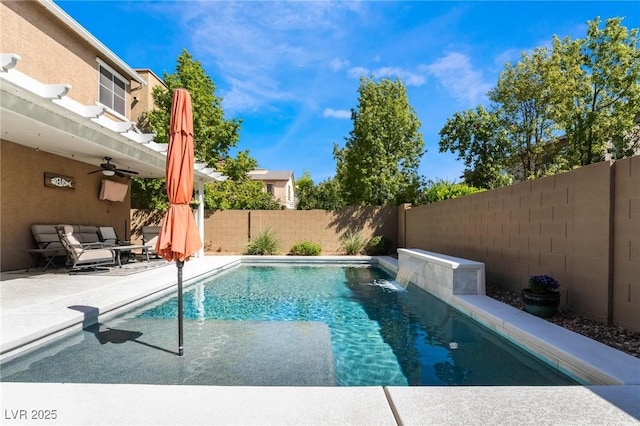 view of swimming pool featuring pool water feature, ceiling fan, and a patio area