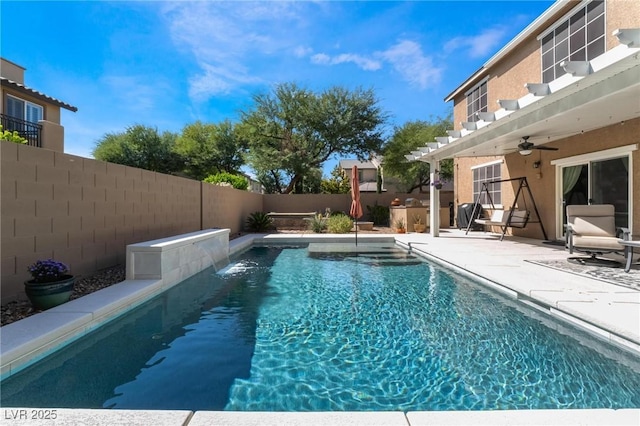 view of pool featuring pool water feature, ceiling fan, and a patio area