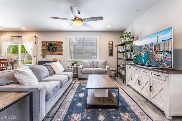 living room with ceiling fan and light hardwood / wood-style floors