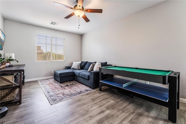 living room with ceiling fan, wood-type flooring, and billiards