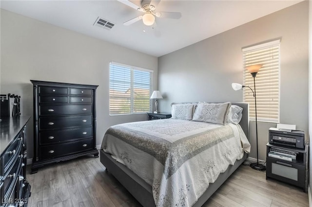 bedroom with ceiling fan and hardwood / wood-style flooring