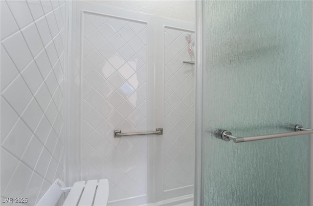 bathroom with a shower with shower door