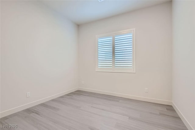 empty room with light hardwood / wood-style flooring