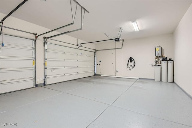 garage featuring tankless water heater and a garage door opener